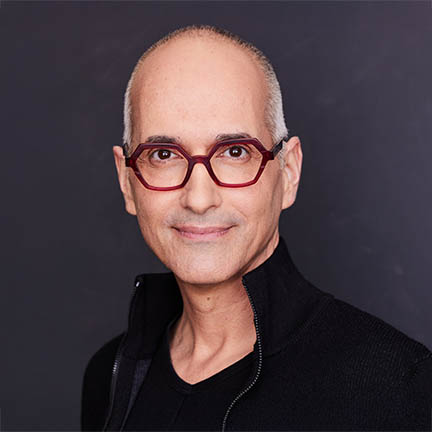 Headshot photo of Lee Wind in black sweater looking directly at the camera.